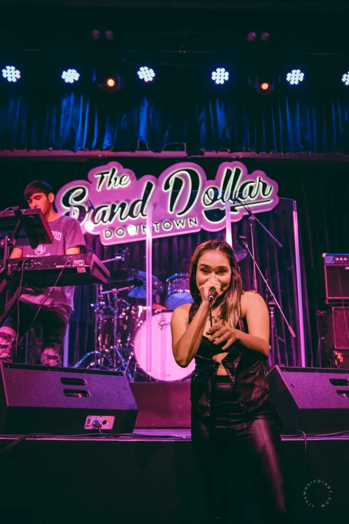 Madison Deaver standing in front of the stage at The Sand Dollar in Downtown Las Vegas | Photo by Miranda Mendelson, LiveMusicDiary.com
