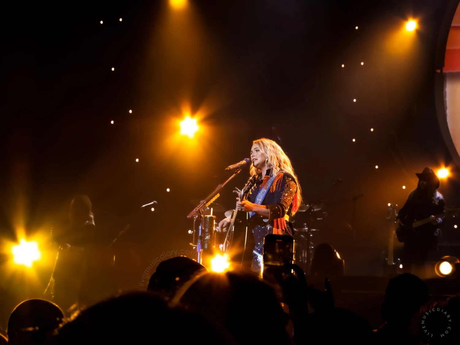Miranda lambert on stage at a distance during her Velvet Rodeo Las Vegas Residency, with the audience in the foreground. 4/2/2023 | Photo by Miranda Mendelson, LiveMusicDiary.com
